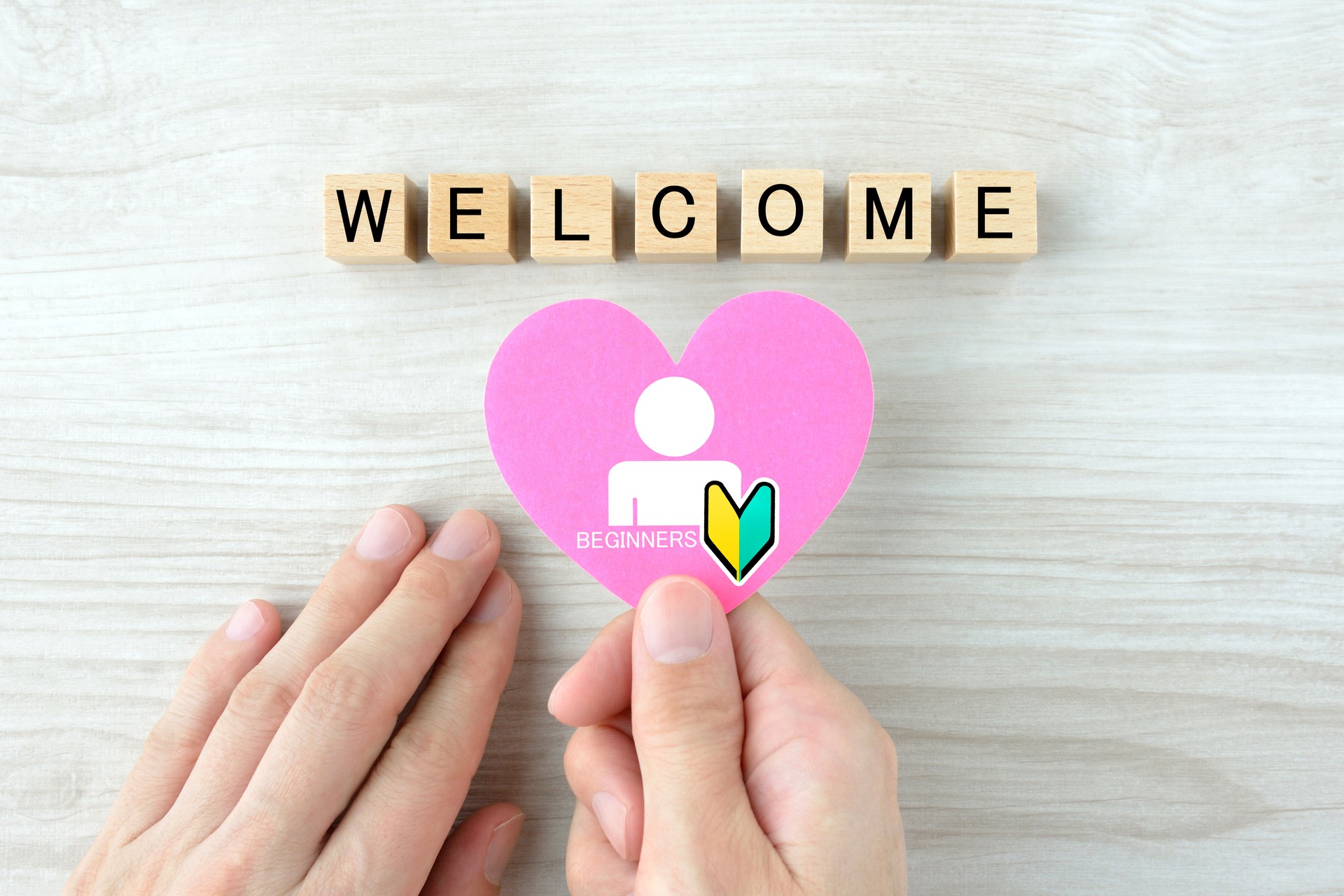 Heart object with beginner pictogram and wooden blocks with WELCOME word